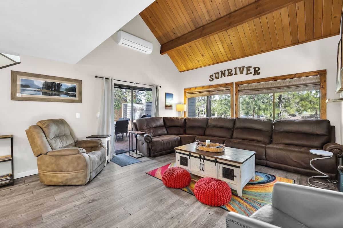 Living room with vaulted wood ceiling and Sunriver wall sign