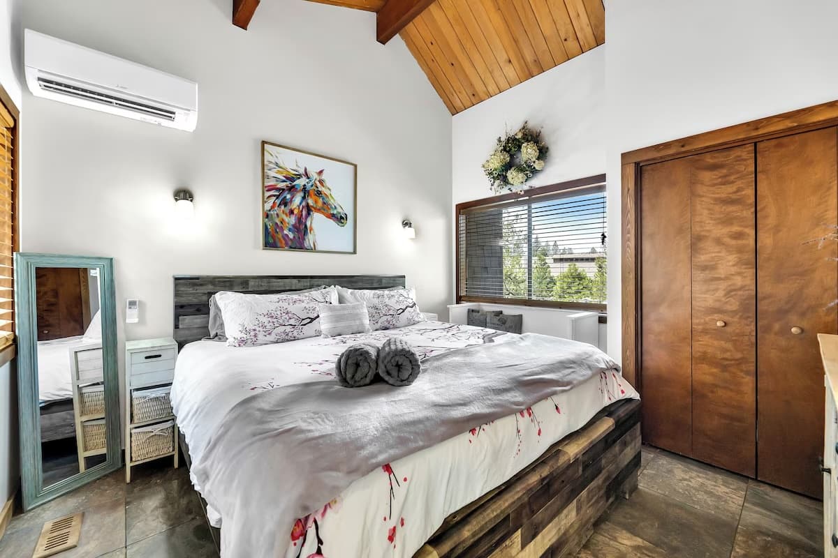Bright bedroom with vaulted wood ceiling