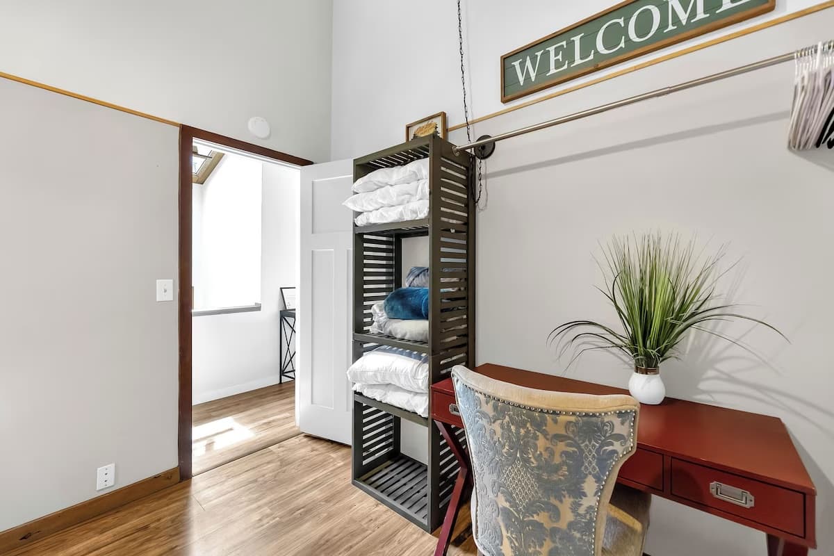 Desk nook with linen storage and welcome sign