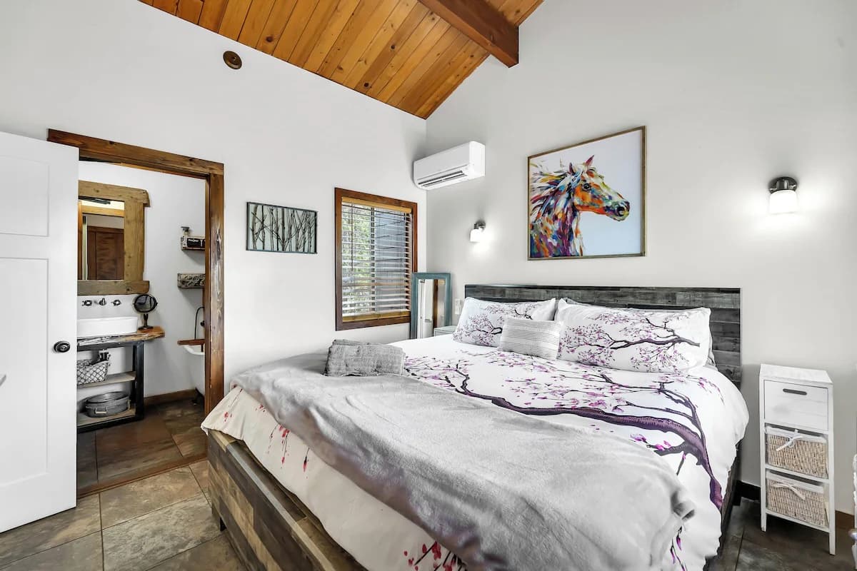 Primary bedroom with wood ceiling and ensuite vanity