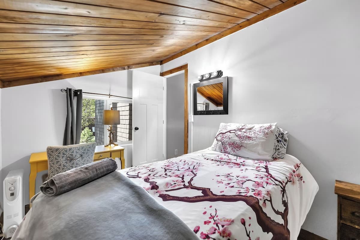 Loft sleeping area with wood ceiling